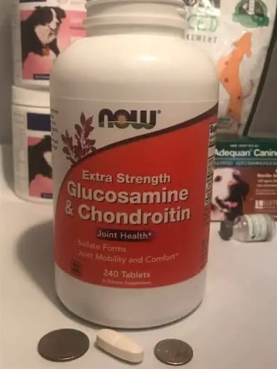 Image of Human Grade Glucosamine and Chondroitin for dogs and capsule size when compared to the size of a quarter